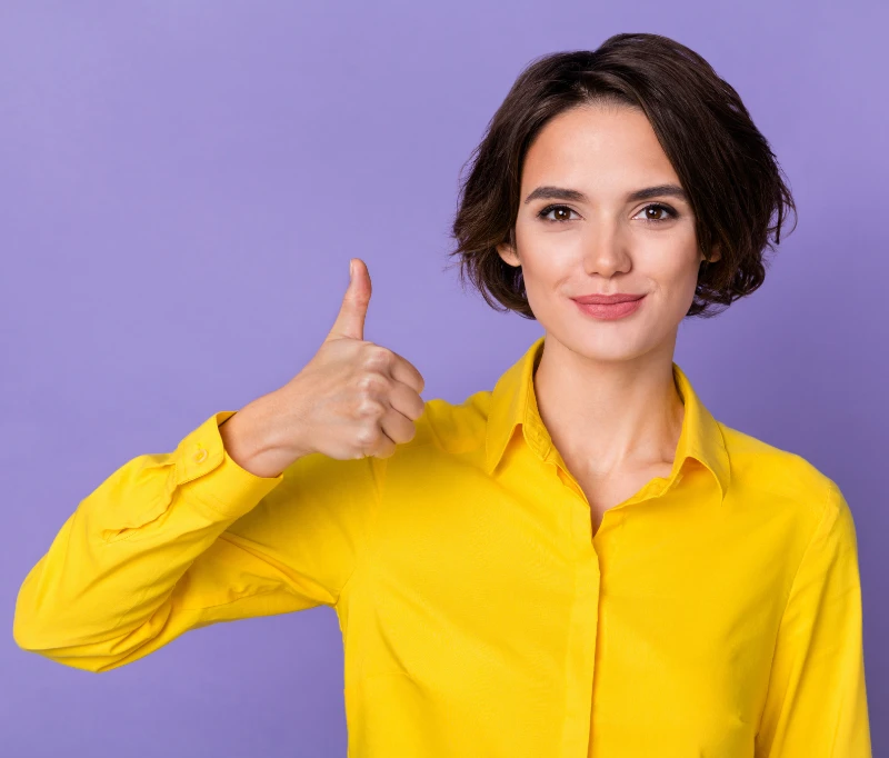 Smiling woman wearing yellow shirt